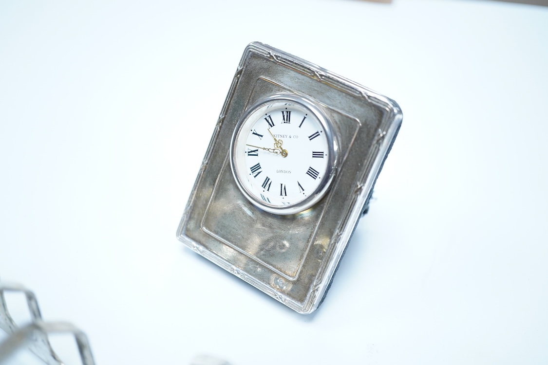 A group of assorted silver, to include a pair of modern five bar toast racks, a George V card case, a sterling vesta case, four assorted condiments, two mounted toilet bottles, mounted timepiece, a modern wooden handled